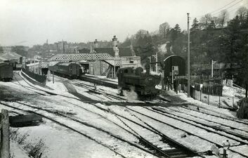1963: Bridgnorth, GWR Pannier 3619 taking water in platform 1 after detaching from Southbound passenger with snow