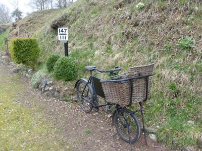 An old bicycle on the platform next to milepost 147¾