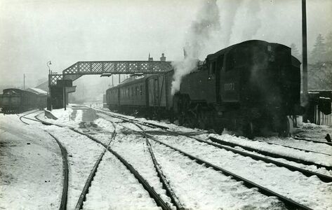 1963: View north of southbound BR 4MT 80072 departing platform 1 in falling snow (Sellick Collection)