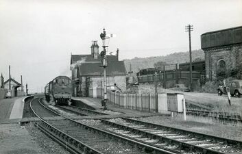 1961: Buildwas, View east of westbound steam-hauled Severn Valley passenger, and northbound service in the Much Wenlock platforms above/behind