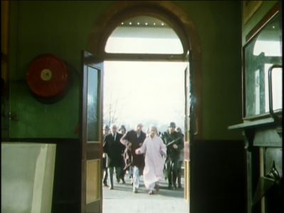 The pursuing throng enters the booking office
